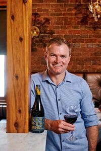 Richie Vandenberg with a bottle of Vandenberg Ari Shiraz